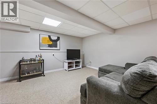 Carpeted room with light grey walls and a drop ceiling featuring recessed lighting - 315 Mayview Crescent Unit# B, Waterloo, ON 