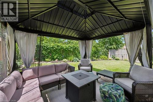 Black metal gazebo featuring a solid roof, privacy curtains, and mesh screens - 315 Mayview Crescent Unit# B, Waterloo, ON 