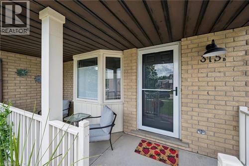 Inviting front porch featuring a brick facade, white railing, and an architectural bay window - 315 Mayview Crescent Unit# B, Waterloo, ON 