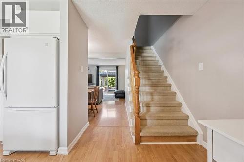 Carpeted staircase with wooden handrail - 315 Mayview Crescent Unit# B, Waterloo, ON 