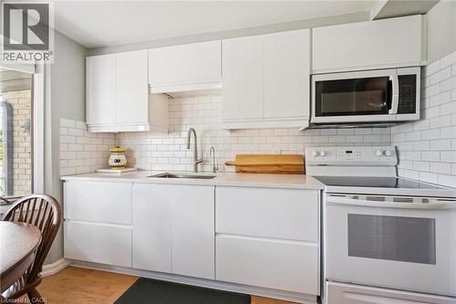 Modern kitchen featuring white flat-panel cabinetry and white subway tile backsplash - 315 Mayview Crescent Unit# B, Waterloo, ON 