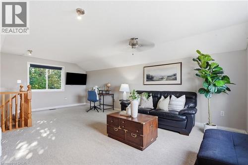 Expansive bonus room featuring sloped ceilings, recessed lighting, neutral carpeting, a window, and a ceiling fan - 128 Houghton Street, Cambridge, ON 