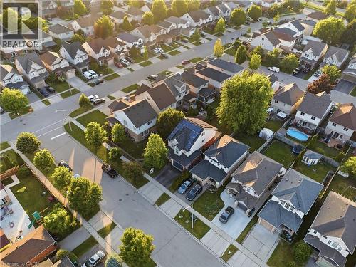 Residential neighborhood featuring detached homes with varied architectural styles, mature trees, paved streets, and sidewalks - 128 Houghton Street, Cambridge, ON 