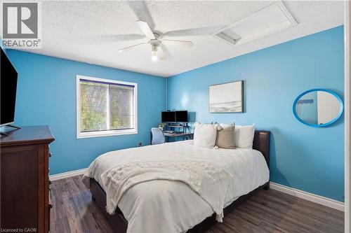 Room featuring wood-finish flooring, a ceiling fan with integrated lighting, and a window with blinds - 128 Houghton Street, Cambridge, ON - Indoor Photo Showing Bedroom