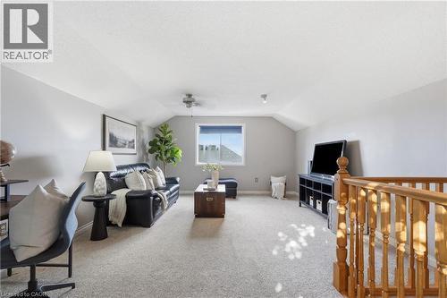 Spacious bonus room featuring vaulted ceilings, light gray wall tones, and neutral carpet flooring - 128 Houghton Street, Cambridge, ON - Indoor