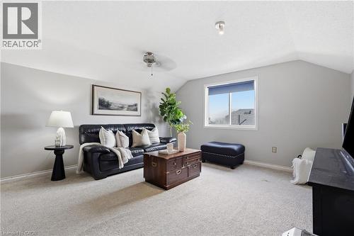 Carpeted room featuring sloped ceilings, a window with exterior views, and neutral wall paint - 128 Houghton Street, Cambridge, ON - Indoor