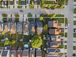 Aerial perspective showcasing residential properties with established landscaping - 
