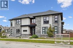 Contemporary exterior featuring a combination of stone veneer and stucco finishes - 