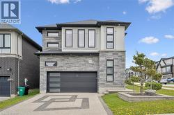 Modern two-story residence featuring a stone and stucco exterior - 