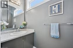 Bathroom vanity featuring a white oval sink, chrome faucet, and speckled countertop - 