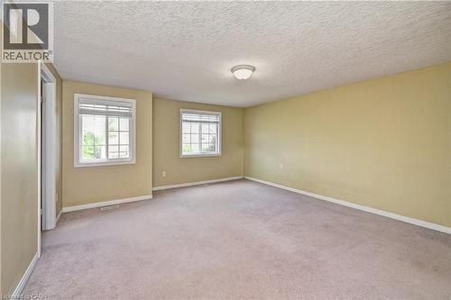 Spacious room featuring neutral carpeting and light beige wall tones - 760 Paris Boulevard, Waterloo, ON 