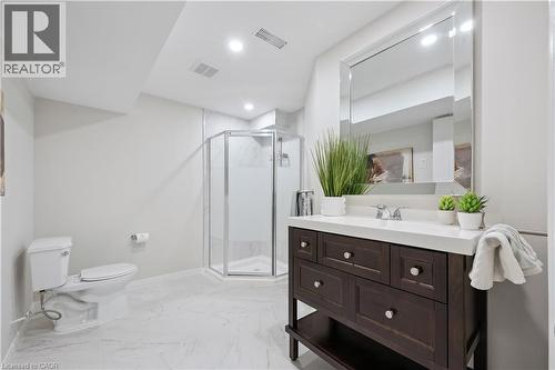 Bathroom featuring a dark wood-finish vanity with a white countertop and chrome fixtures - 87 Ridge Road, Cambridge, ON 