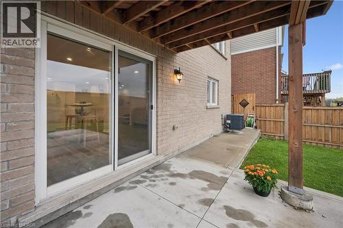 Concrete patio with a full brick exterior and a sliding glass door - 87 Ridge Road, Cambridge, ON 