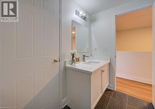 Bathroom vanity featuring a single basin sink, brushed nickel faucet, and integrated countertop - 139 Werstine Terrace, Cambridge, ON 
