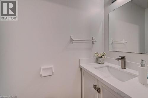 Vanity featuring a white countertop, undermount sink, and matte gray faucet - 139 Werstine Terrace, Cambridge, ON 