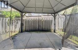 Outdoor gazebo with a metal frame and roof, featuring integrated mesh screens - 