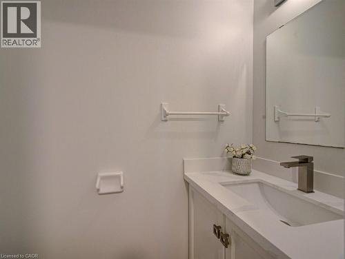 Bathroom vanity featuring a rectangular undermount sink, a light-colored countertop, and a brushed nickel faucet - 139 Werstine Terrace, Cambridge, ON 