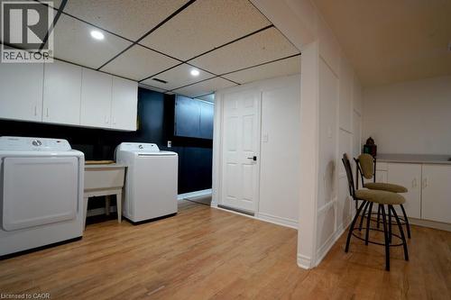 Dedicated laundry area featuring a utility sink and a washer and dryer set - 147 Muriel Crescent, London, ON 