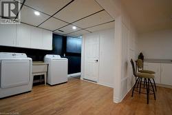 Dedicated laundry area featuring a utility sink and a washer and dryer set - 