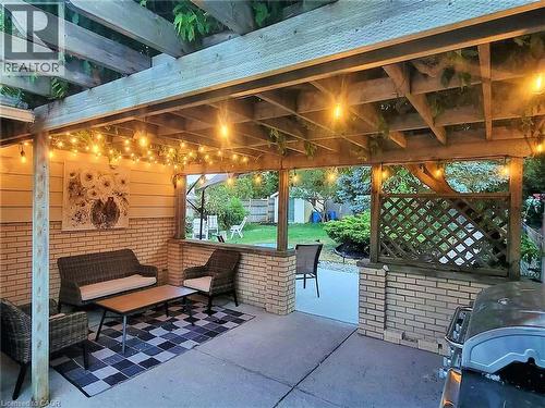 Covered patio featuring a wood pergola with string lighting - 147 Muriel Crescent, London, ON 