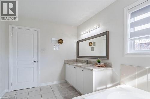 Double vanity with light-toned countertop, undermount sinks, and white cabinetry - 47 Hawke Crescent, New Tecumseth, ON 