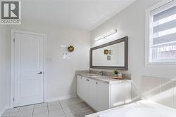 Double vanity with light-toned countertop, undermount sinks, and white cabinetry - 
