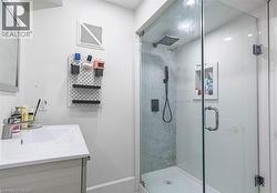 Glass-enclosed shower with a rainfall showerhead and handheld sprayer - 