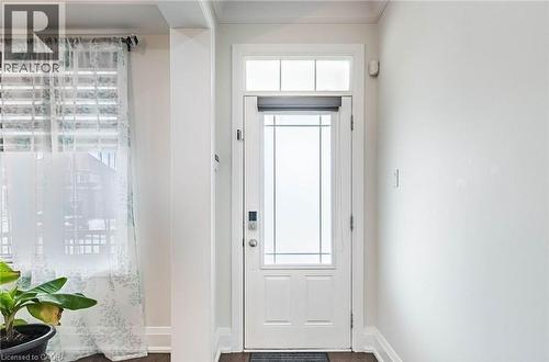 White entry door with decorative glass inserts and transom window - 47 Hawke Crescent, New Tecumseth, ON 