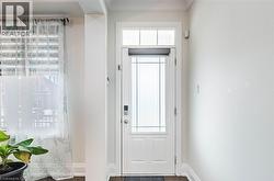 White entry door with decorative glass inserts and transom window - 