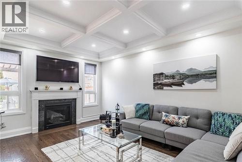 Living area featuring dark wood-finish flooring and a coffered ceiling with recessed lighting - 47 Hawke Crescent, New Tecumseth, ON 