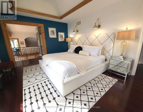 Primary suite with fireplace & private balcony. - 6 Pinehurst Lane, Springwater, ON - Indoor Photo Showing Bedroom