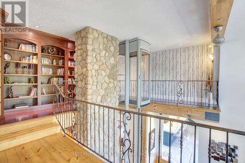 Custom built-in library & convenient elevator-lift - 6 Pinehurst Lane, Springwater, ON - Indoor Photo Showing Other Room