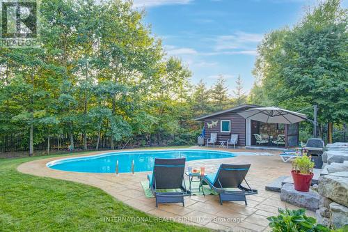 Patterned concrete pool deck and built-in bbq. - 6 Pinehurst Lane, Springwater, ON - Outdoor With In Ground Pool