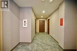 Hallway with textured wall finishes, recessed lighting, and a patterned carpet runner - 