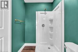 Shower stall featuring a white multi-piece surround with integrated shelving - 
