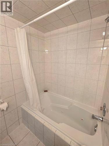 Jetted soaking tub with a tiled surround and chrome fixtures - 2373 E King Street E Unit# 37, Hamilton, ON 