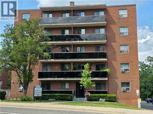 Multi-story brick building featuring multiple private balconies with dark glass railings - 2373 E King Street E Unit# 37, Hamilton, ON 