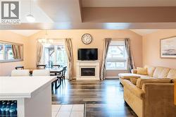 Open-concept living space featuring vaulted ceilings and wood-finish flooring - 