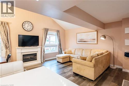 Living area featuring a prominent fireplace with a classic white mantel - 171 Mcnichol Drive, Cambridge, ON 