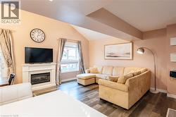 Living area featuring a prominent fireplace with a classic white mantel - 