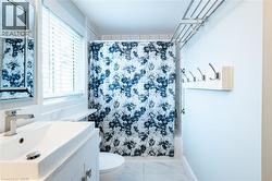 Bathroom featuring a built-in tub with tile surround, white vanity with integrated sink, chrome faucet, and a wall-mounted mirror - 