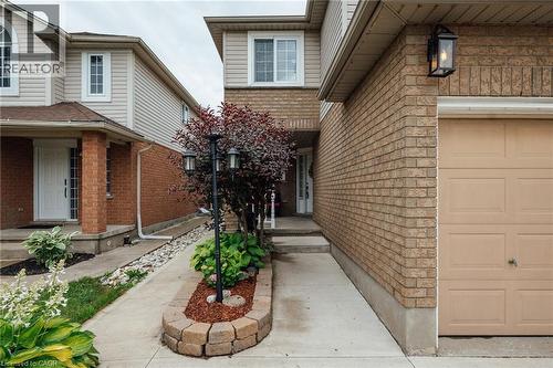 Exterior featuring brick and siding, a single-car garage, and a concrete pathway - 171 Mcnichol Drive, Cambridge, ON 