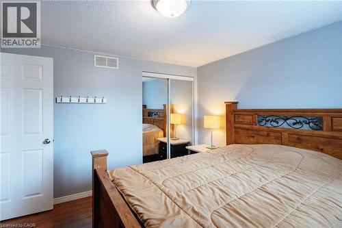 Wood-finish flooring with a light blue wall color and white trim - 171 Mcnichol Drive, Cambridge, ON 