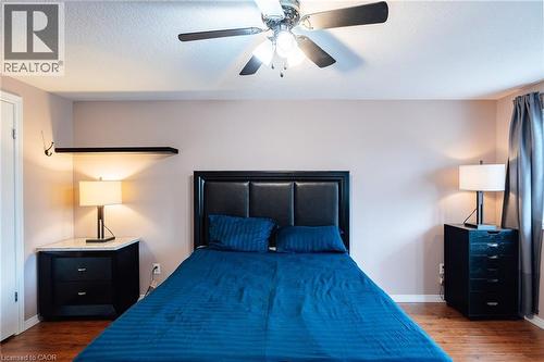 Spacious room featuring wood-finish flooring, a ceiling fan with integrated lighting, and a built-in floating shelf - 171 Mcnichol Drive, Cambridge, ON 