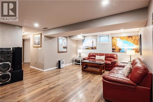 Spacious room featuring wood-finish flooring, recessed lighting, and neutral wall tones - 171 Mcnichol Drive, Cambridge, ON 