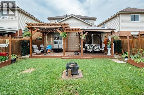 Spacious backyard featuring a wooden deck with a pergola, a separate gazebo, and a fire pit area - 171 Mcnichol Drive, Cambridge, ON 