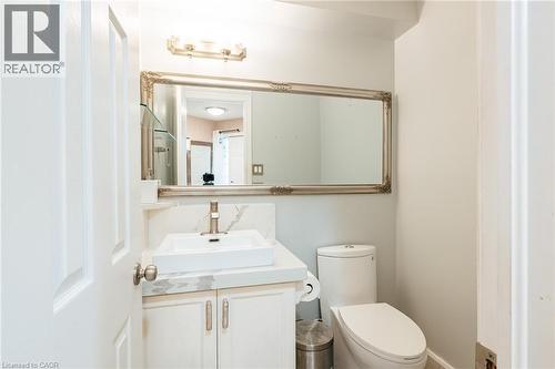 Vanity featuring a vessel sink, single-handle faucet, and white cabinetry - 171 Mcnichol Drive, Cambridge, ON 