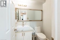 Vanity featuring a vessel sink, single-handle faucet, and white cabinetry - 