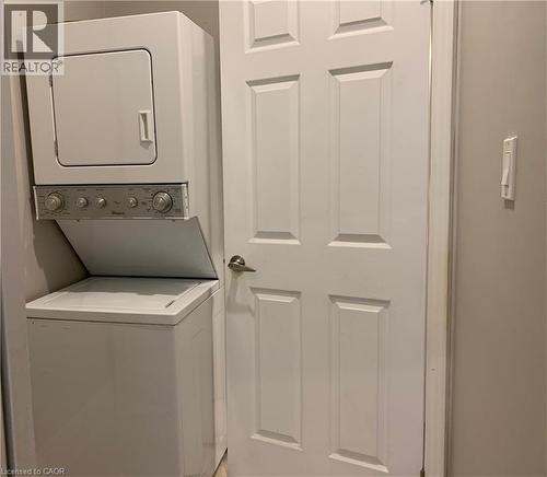 Stacked washer and dryer unit, featuring a white finish and a compact design - 405 Macnab Street N, Hamilton, ON 