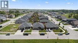 Aerial perspective showcasing a residential neighborhood with uniformly designed single-story homes - 